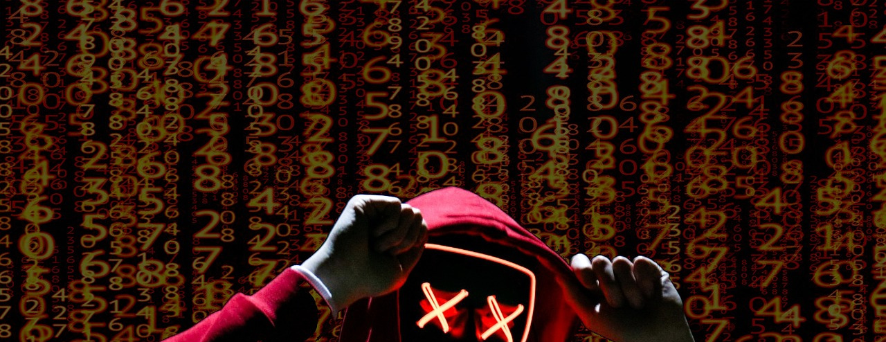 hacker hooded laptop dark